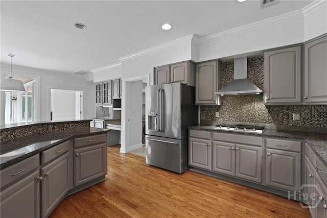 8 Boars Nest Ln, Savannah, GA 31411 - kitchen featuring stainless steel refrigerator with ice dispenser, wall chimney exhaust hood, gray cabinetry, crown molding, and decorative backsplash