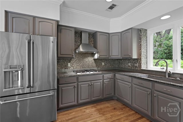 8 Boars Nest Ln, Savannah, GA 31411 - kitchen with stainless steel refrigerator with ice dispenser, gray cabinetry, wall chimney exhaust hood, ornamental molding, and tasteful backsplash