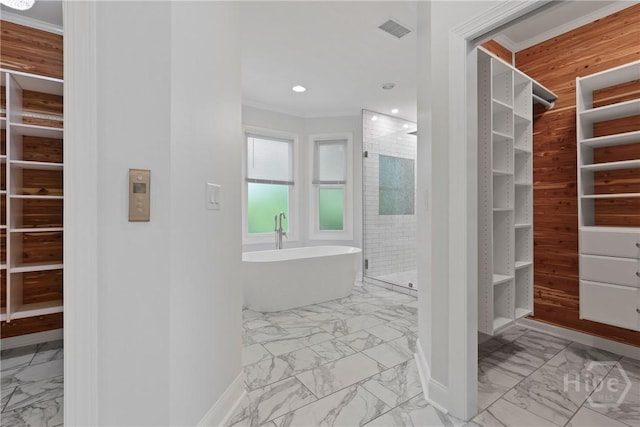 8 Boars Nest Ln, Savannah, GA 31411 - bathroom featuring marble finish flooring, a walk in closet, a freestanding tub, ornamental molding, and a shower stall