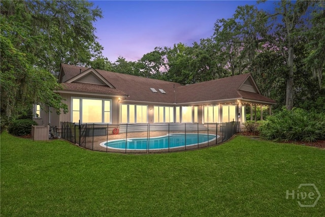 8 Boars Nest Ln, Savannah, GA 31411 - back of property at dusk with a lawn and a shingled roof
