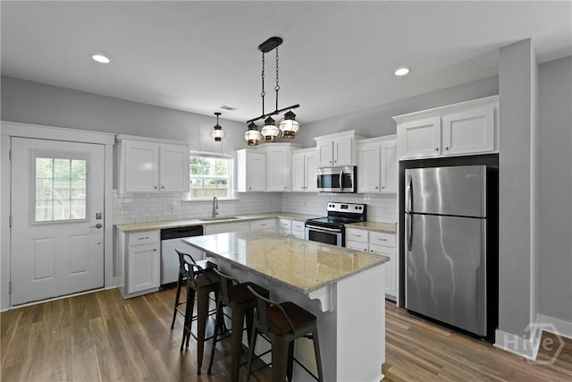 623 E Henry St, Savannah, GA 31401 - kitchen featuring stainless steel appliances, backsplash, white cabinets, and recessed lighting