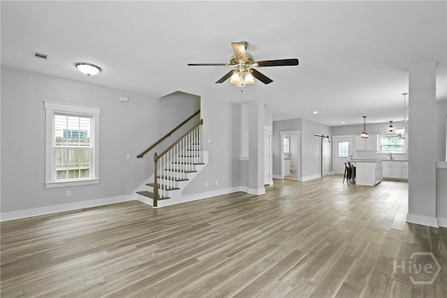 623 E Henry St, Savannah, GA 31401 - unfurnished living room with stairway, ceiling fan, light wood-type flooring, and recessed lighting