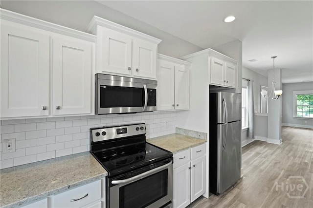 623 E Henry St, Savannah, GA 31401 - kitchen featuring stainless steel appliances, white cabinetry, light wood-style flooring, decorative backsplash, and recessed lighting