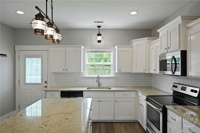 623 E Henry St, Savannah, GA 31401 - kitchen with stainless steel appliances, white cabinets, tasteful backsplash, pendant lighting, and recessed lighting