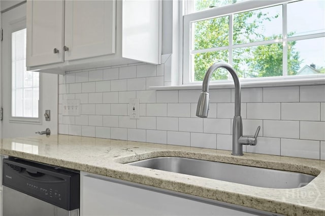 623 E Henry St, Savannah, GA 31401 - kitchen with dishwasher, white cabinets, decorative backsplash, and plenty of natural light