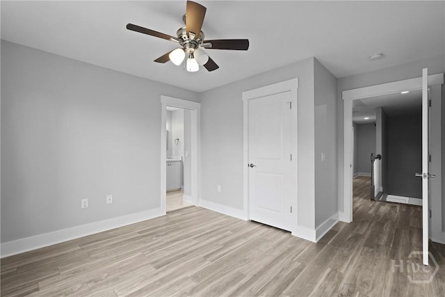 623 E Henry St, Savannah, GA 31401 - unfurnished bedroom with wood finished floors, ensuite bath, and ceiling fan