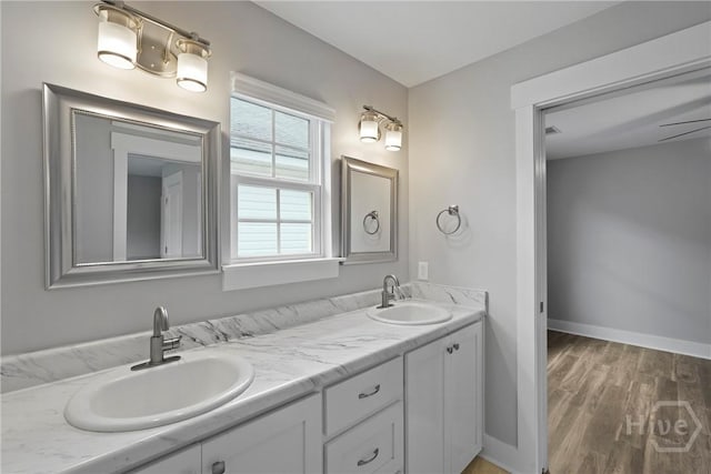 623 E Henry St, Savannah, GA 31401 - full bathroom with double vanity and wood finished floors