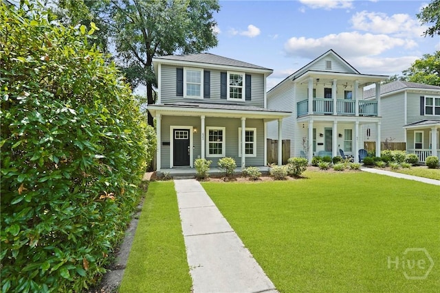 623 E Henry St, Savannah, GA 31401 - view of front of property featuring covered porch, a front yard, and a balcony