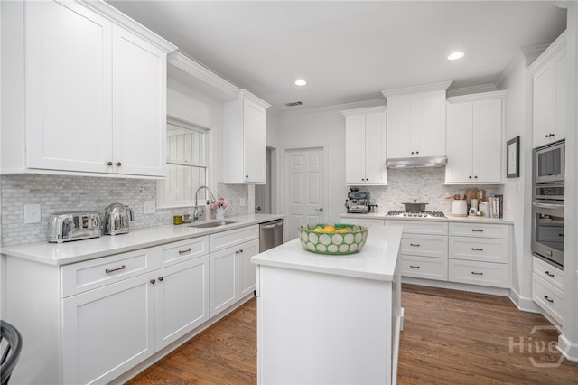 3 Franklin Creek Rd S, Savannah, GA 31411 - kitchen with appliances with stainless steel finishes, backsplash, light countertops, white cabinets, and a kitchen island