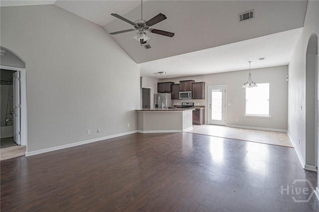 1506 Bayberry Dr, Hinesville, GA 31313 - unfurnished living room with high vaulted ceiling, a ceiling fan, arched walkways, and wood finished floors
