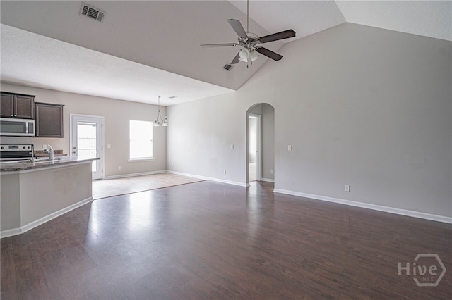 1506 Bayberry Dr, Hinesville, GA 31313 - unfurnished living room with a ceiling fan, arched walkways, wood finished floors, and high vaulted ceiling