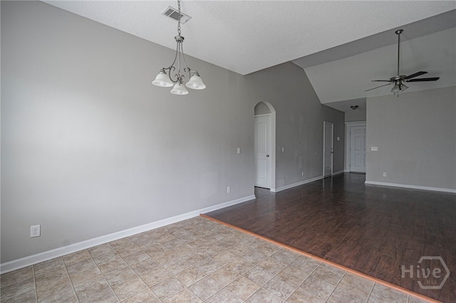 1506 Bayberry Dr, Hinesville, GA 31313 - spare room featuring arched walkways, a ceiling fan, wood finished floors, a chandelier, and high vaulted ceiling