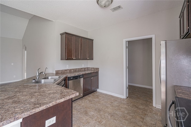 1506 Bayberry Dr, Hinesville, GA 31313 - kitchen with stainless steel appliances, dark brown cabinetry, arched walkways, a peninsula, and a textured ceiling