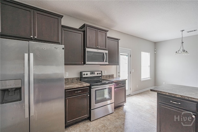 1506 Bayberry Dr, Hinesville, GA 31313 - kitchen featuring stainless steel appliances, dark brown cabinets, a textured ceiling, hanging light fixtures, and dark countertops