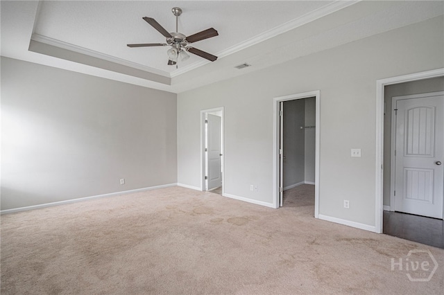1506 Bayberry Dr, Hinesville, GA 31313 - unfurnished bedroom featuring a tray ceiling, ornamental molding, carpet floors, a walk in closet, and a closet