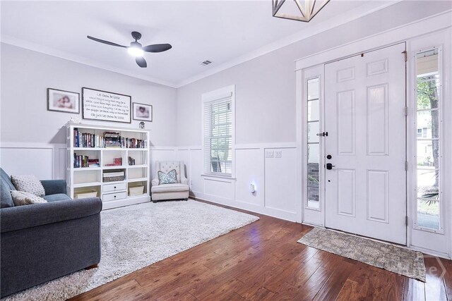 370 Blackjack Oak Dr W, Richmond Hill, GA 31324 - foyer with dark wood finished floors, a wainscoted wall, a ceiling fan, crown molding, and a decorative wall