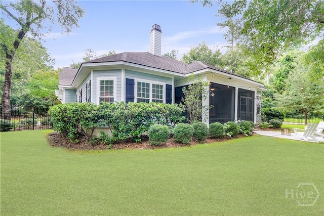 370 Blackjack Oak Dr W, Richmond Hill, GA 31324 - back of house with a sunroom, a chimney, a patio area, and roof with shingles