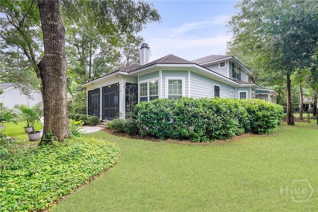 370 Blackjack Oak Dr W, Richmond Hill, GA 31324 - back of property featuring a sunroom, a chimney, and a yard