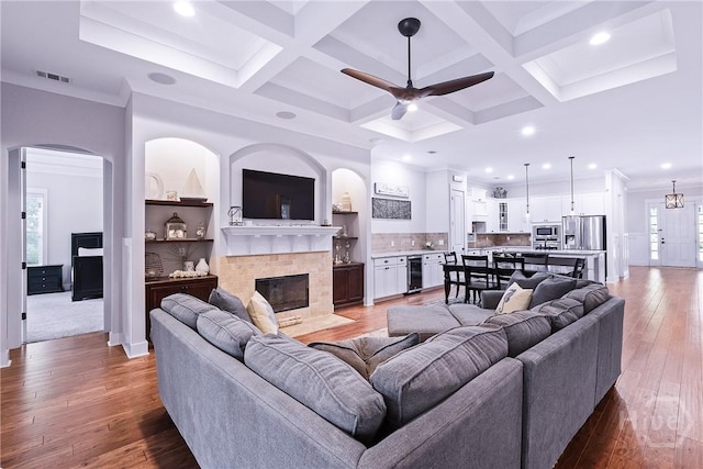 370 Blackjack Oak Dr W, Richmond Hill, GA 31324 - living room featuring beverage cooler, a tile fireplace, ceiling fan, beam ceiling, and recessed lighting