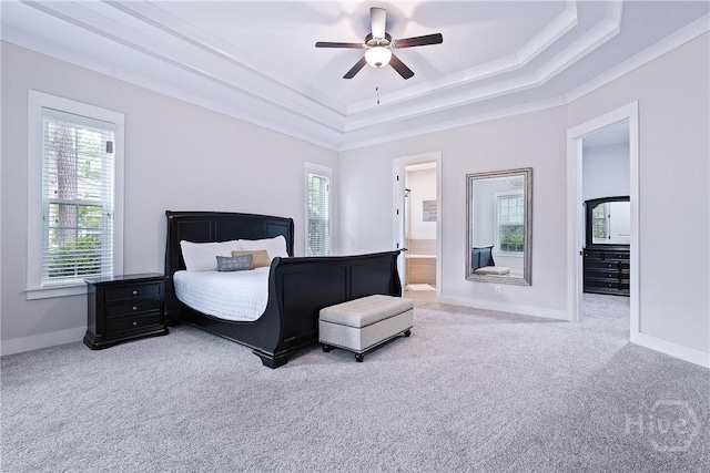 370 Blackjack Oak Dr W, Richmond Hill, GA 31324 - carpeted bedroom featuring a tray ceiling, multiple windows, ornamental molding, a ceiling fan, and connected bathroom