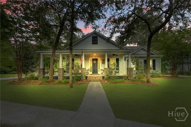 370 Blackjack Oak Dr W, Richmond Hill, GA 31324 - view of front of home with a ceiling fan, a porch, and a front yard