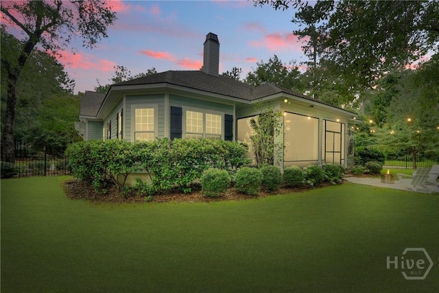 370 Blackjack Oak Dr W, Richmond Hill, GA 31324 - back of house at dusk with a chimney