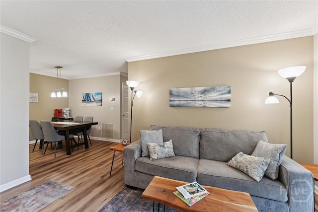 12300 Apache Ave Unit 1003, Savannah, GA 31419 - living area featuring wood finished floors, crown molding, and a textured ceiling