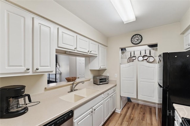 12300 Apache Ave Unit 1003, Savannah, GA 31419 - kitchen featuring freestanding refrigerator, light countertops, white cabinetry, and light wood finished floors