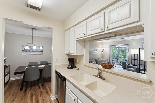 12300 Apache Ave Unit 1003, Savannah, GA 31419 - kitchen featuring stainless steel dishwasher, wood finished floors, white cabinets, light countertops, and hanging light fixtures