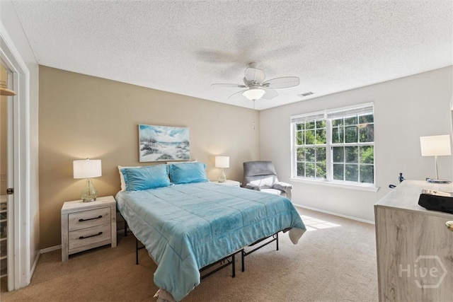12300 Apache Ave Unit 1003, Savannah, GA 31419 - bedroom with carpet floors, a textured ceiling, and a ceiling fan