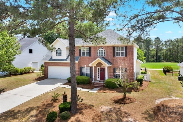 306 Walthour Dr, Rincon, GA 31326 - colonial house with brick siding, concrete driveway, a front yard, and a garage