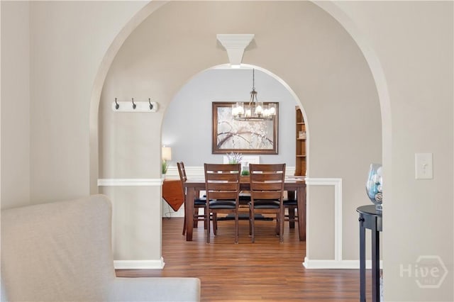 306 Walthour Dr, Rincon, GA 31326 - dining room featuring wood finished floors, arched walkways, and a chandelier