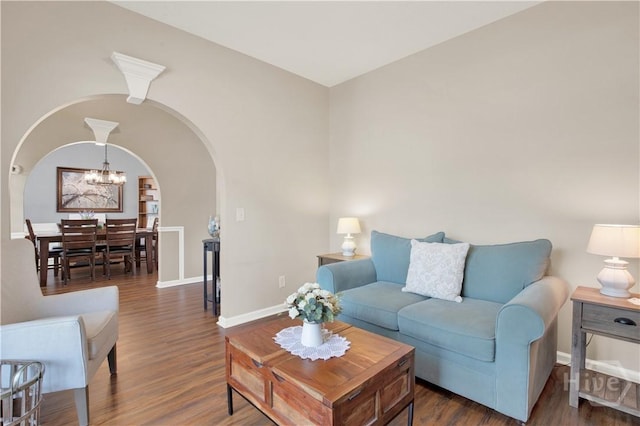 306 Walthour Dr, Rincon, GA 31326 - living room with arched walkways, a chandelier, and wood finished floors