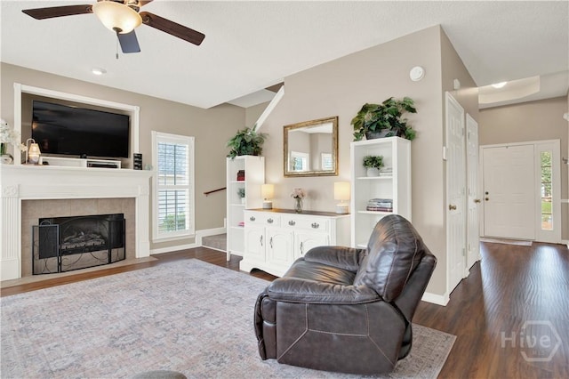 306 Walthour Dr, Rincon, GA 31326 - living room featuring dark wood-style flooring, a ceiling fan, and a fireplace