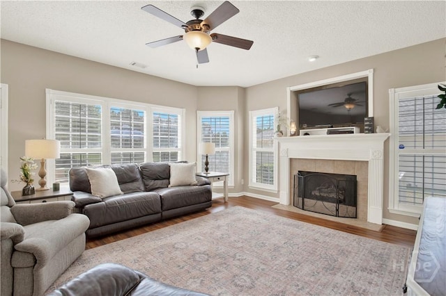 306 Walthour Dr, Rincon, GA 31326 - living room with ceiling fan, wood finished floors, a fireplace, and a textured ceiling