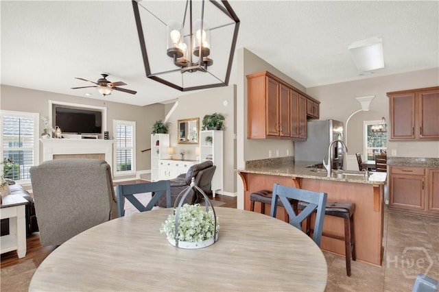 306 Walthour Dr, Rincon, GA 31326 - dining area with a chandelier, ceiling fan, and a tiled fireplace