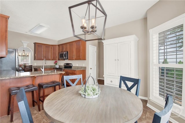 306 Walthour Dr, Rincon, GA 31326 - dining room with a chandelier and baseboards