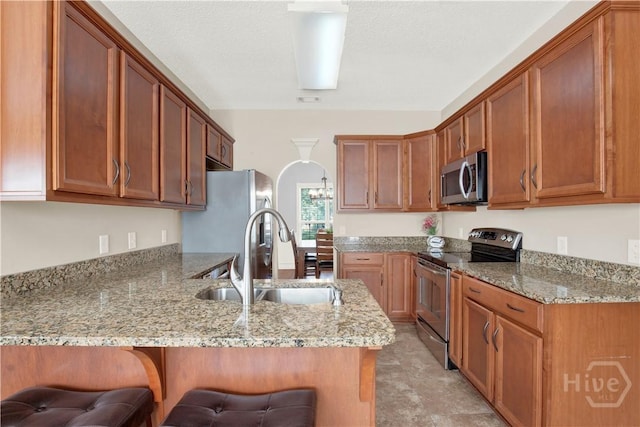 306 Walthour Dr, Rincon, GA 31326 - kitchen featuring stainless steel appliances, a peninsula, a breakfast bar, and light stone counters
