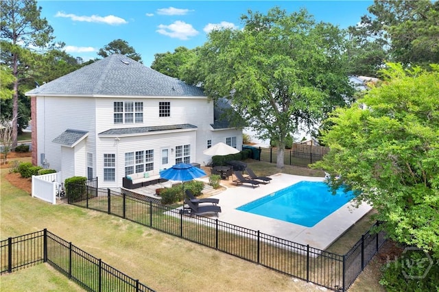 306 Walthour Dr, Rincon, GA 31326 - back of property with an outdoor hangout area, a fenced backyard, a patio, and a shingled roof