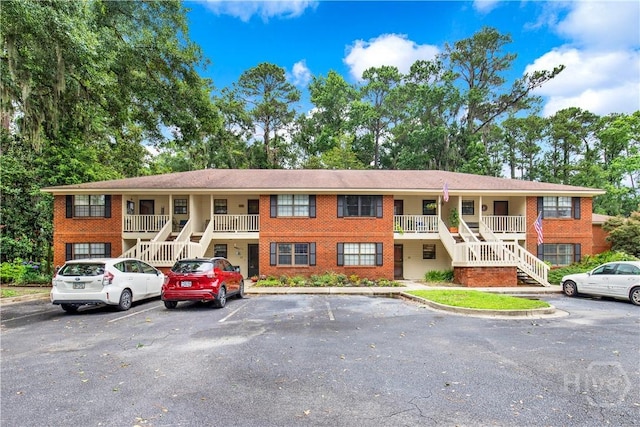 25 Colony Park Dr, Savannah, GA 31406 - view of building exterior featuring stairs and uncovered parking