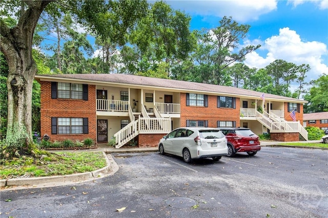 25 Colony Park Dr, Savannah, GA 31406 - view of property featuring stairs and uncovered parking