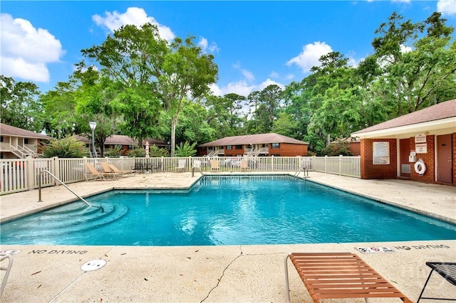 25 Colony Park Dr, Savannah, GA 31406 - community pool featuring a patio area and view of scattered trees