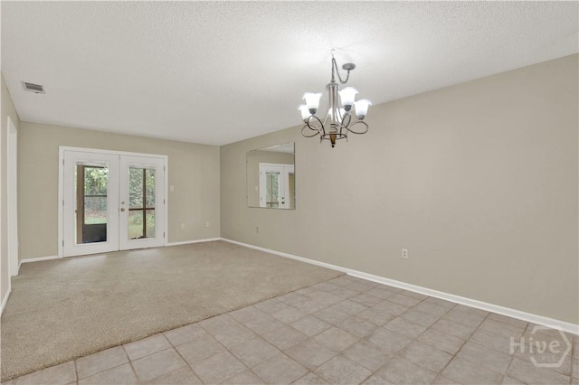 25 Colony Park Dr, Savannah, GA 31406 - spare room with a chandelier, french doors, light carpet, and a textured ceiling