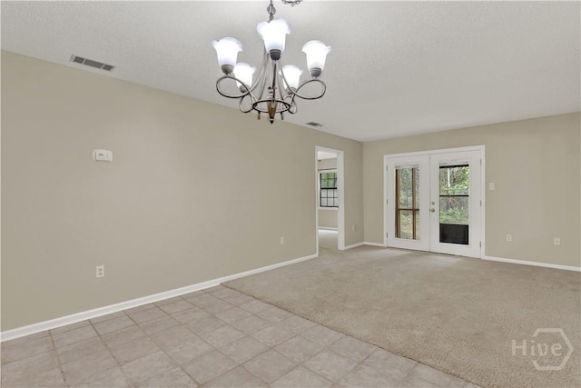 25 Colony Park Dr, Savannah, GA 31406 - spare room featuring a chandelier, light carpet, a textured ceiling, and french doors