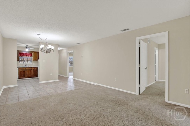25 Colony Park Dr, Savannah, GA 31406 - unfurnished living room featuring a chandelier, light tile patterned floors, light carpet, and a ceiling fan