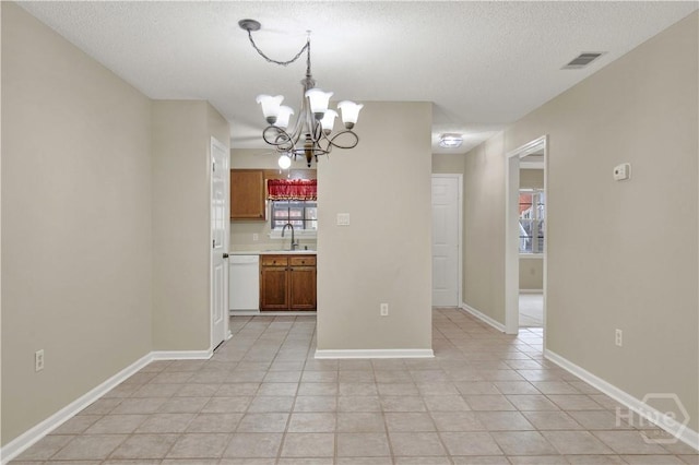 25 Colony Park Dr, Savannah, GA 31406 - unfurnished dining area with a chandelier, a textured ceiling, and light tile patterned flooring