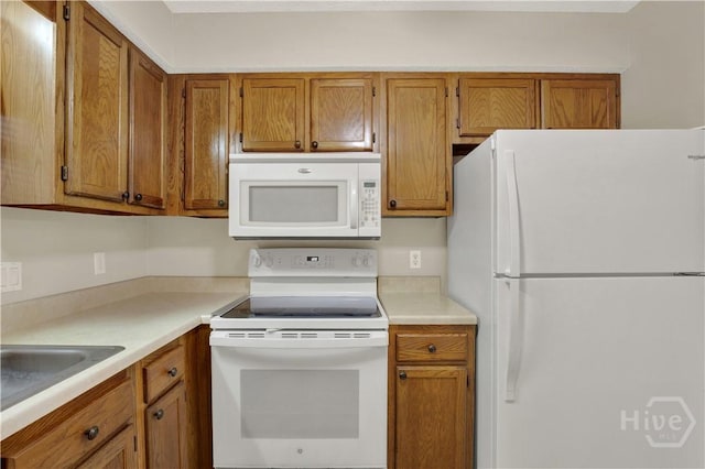 25 Colony Park Dr, Savannah, GA 31406 - kitchen with white appliances, brown cabinets, and light countertops