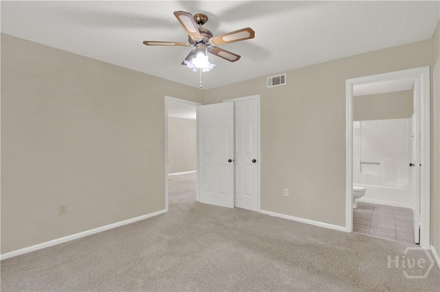 25 Colony Park Dr, Savannah, GA 31406 - unfurnished bedroom with carpet flooring, ensuite bath, a ceiling fan, and a closet