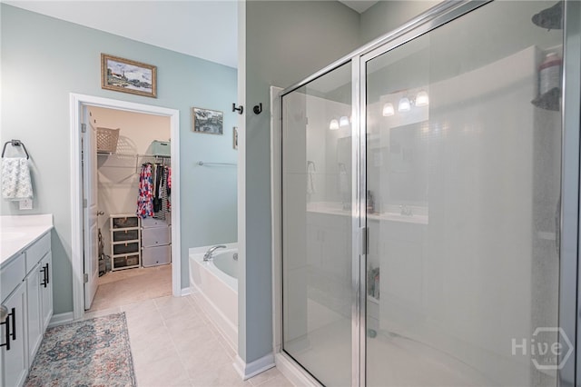 143 Arusha Ave, Savannah, GA 31419 - bathroom featuring vanity, a walk in closet, a stall shower, a bath, and tile patterned floors