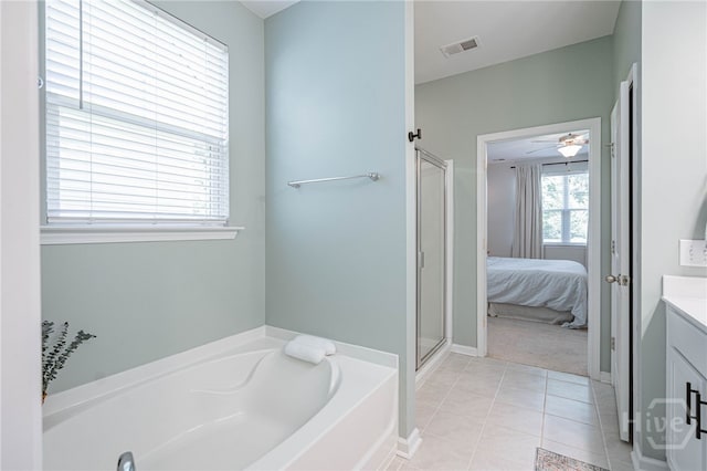143 Arusha Ave, Savannah, GA 31419 - ensuite bathroom with a garden tub, vanity, a shower with shower door, tile patterned floors, and a ceiling fan